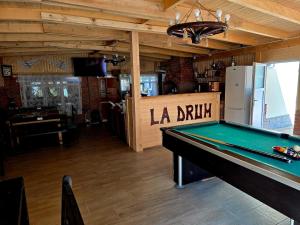 a pool table in a room with a sign on it at Casa Deluxe in Slănic-Moldova