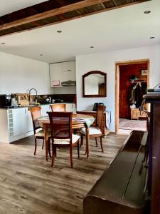 a kitchen and dining room with a table and chairs at Prociówka in Ciche