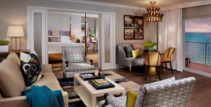 a living room with a bedroom and a living room with a bed at La Playa Beach & Golf Resort, a Noble House Resort in Naples