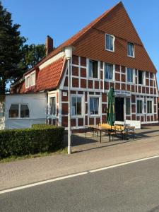 a building with a bench in front of it at Gasthaus zur Grenze in Cuxhaven