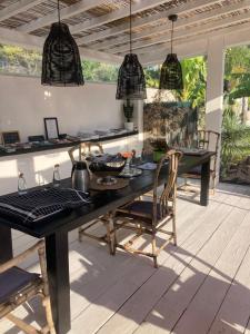 a dining room with a table and chairs and pendant lights at Villa Le Sud in Cassis