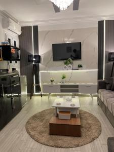 a living room with a couch and a coffee table at Pyramids Elsewedy home in Ghaţāţī