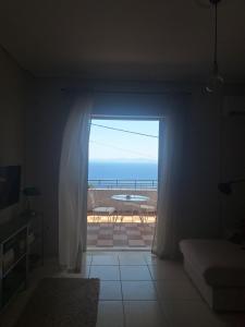 a room with a window with a view of the ocean at Noma apartment in Gythio