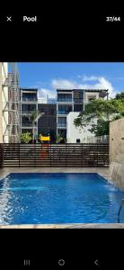 a large blue swimming pool in front of some buildings at Brand New Condo-Sunrise in Puerto Plata