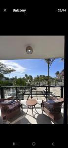 a balcony with a table and chairs and a table and a table and chairs at Brand New Condo-Sunrise in Puerto Plata