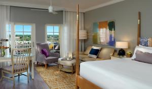 a bedroom with a bed and a living room at La Playa Beach & Golf Resort, a Noble House Resort in Naples