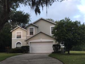 a white house with a garage and a tree at Villa With Private Pool, and Lake Views in Davenport