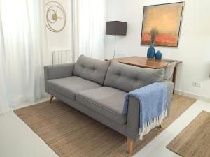 a living room with a couch and a table at Cais das Pedras Pátio Apartment - with washer and dryer machine in Porto