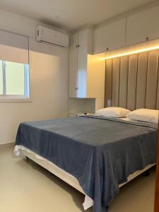 a bedroom with a large bed with a large headboard at Flat 505 Condomínio Topo da Montanha in Chã Grande +27 photos
