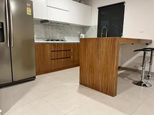 a kitchen with a refrigerator and a counter with a sink at Residencia Santa Fe in San Rafael
