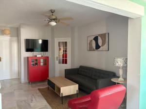 a living room with a couch and a red cabinet at The Bajondillo terrace in Torremolinos