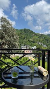 a table on a balcony with a view of a mountain at nateli sakhli Gonio in Batumi