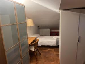 a bedroom with a bed and a desk with a lamp at Villino IRMA in Porto San Giorgio