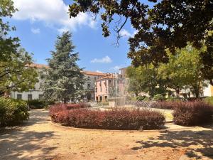 a park with a fountain in front of a building at Suite 31 in Rovigo