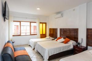 a hotel room with two beds and a couch at Costa Beach in Zorritos +84 photos