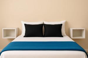 a bed with two night stands on either side of it at Ap quarto climatizado in Santarém
