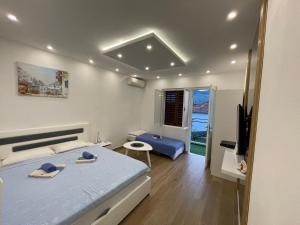 a bedroom with a bed and a tv in it at Apartmani Cicibela in Herceg-Novi