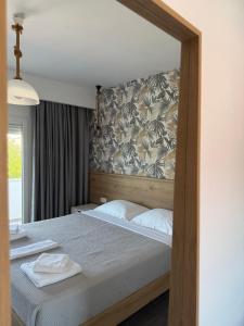 A bed or beds in a room at Lamda Deluxe Apartments
