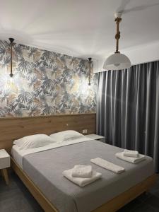A bed or beds in a room at Lamda Deluxe Apartments