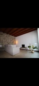 a living room with a white couch and a table at Luce in Grassobbio