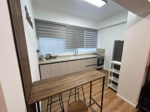 a small kitchen with a sink and a refrigerator at Eden apartment in Haifa