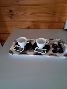 a tray with two cups and saucers on a table at Tchià Ben in Faido +5 photos