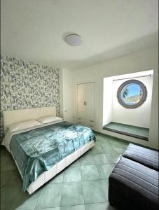 a bedroom with a large bed and a window at L'oblo' sul mare Sorrento Coast in Vico Equense