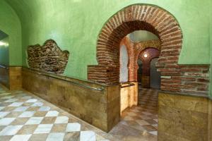 a room with a brick wall and an archway at Hostal Rural Gloria in Graena