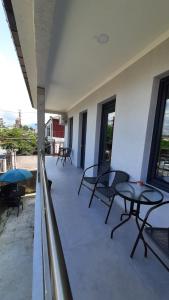 a patio with tables and chairs on a balcony at Weekender guesthouse 6 in K'obulet'i