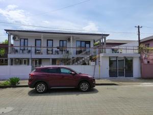 a red car parked in front of a house at Weekender guesthouse 6 in K'obulet'i