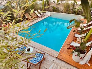 a swimming pool with a deck and chairs next to it at Casa Palma Suites in Vlorë
