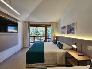 a bedroom with a large bed and a large window at Blu Smart Stay in Búzios