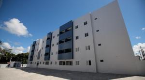 a white building with windows on the side of it at Cantinho da Giza-próx à praia em JP in João Pessoa