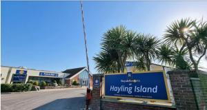 a person walking down a street with a blue sign at Stay static Hayling island holiday park in South Hayling