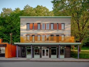 a brick building with orange and orange windows at BADANG Lab in Sainte-Anne-de-Beaupré
