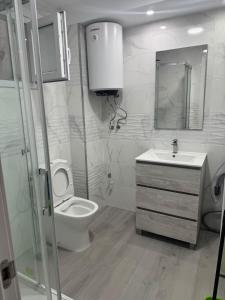 a bathroom with a toilet and a sink at 2 bedroom apartment for rent in Cullera