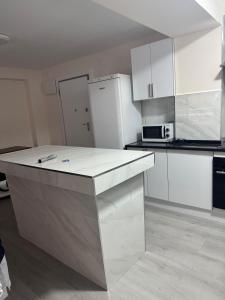 a kitchen with white cabinets and a white counter top at 2 bedroom apartment for rent in Cullera