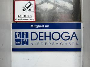a sign on a wall with a sign for a medicacist at Kretschmanns Hotel in Sehnde