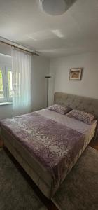 a bedroom with a large bed in a room at Olive Roots Yard House in Trebinje +18 photos