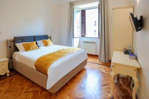 a bedroom with a large bed and a window at Casa Pan in Rome