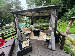 a gazebo with a table and chairs on a deck at S and S Homestead in Rochester
