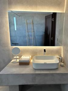 a bathroom with a sink and a mirror at 'Olea Luxury House in Elia Laconias +47 photos