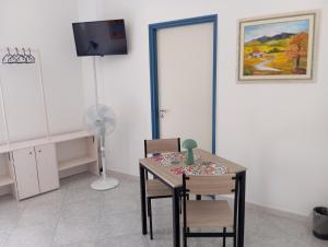 a room with a table and chairs and a fan at Guest House Casa Minardi in Caltagirone
