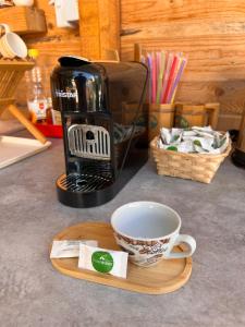 a coffee maker and a cup on a wooden tray at Tranquil Tent Retreat Glamping in Zaljevo