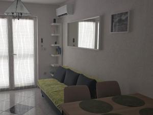 a living room with a couch and a table at Apartment Albatross Ten in Novalja