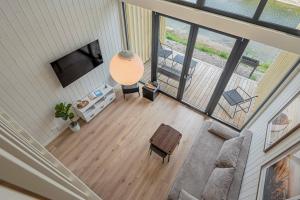 an overhead view of a living room with a couch and a television at Pondside Cabin - Sauna - Terrace - Near Wake Park in Kiauleikiai