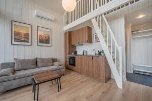 a living room with a couch and a staircase at Palanga Waterhouse in Kiauleikiai +27 photos