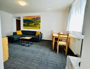 a living room with a couch and a table at Apartmán Amy - Kvilda in Kvilda