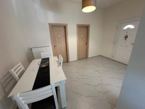 a room with a white table and chairs and a hallway at Thea Thermaikou in Agia Triada +23 photos