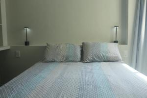 a bedroom with a bed with two pillows at VG Fun Apto 502 in Fortaleza